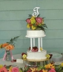 Pillars n flowers beach wedding cake by Beach Weddings Alabama